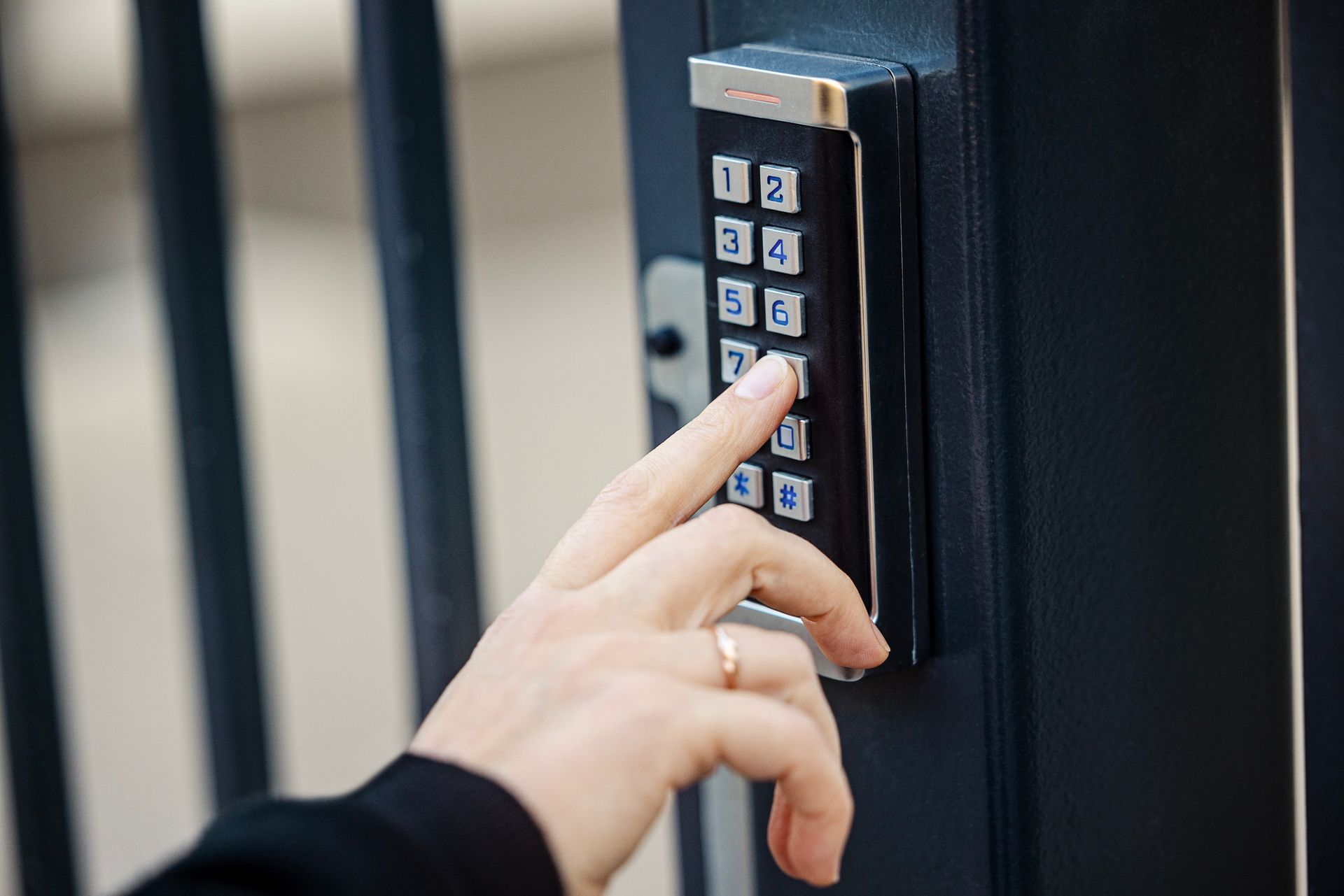 A person is using a keypad to open a gate.