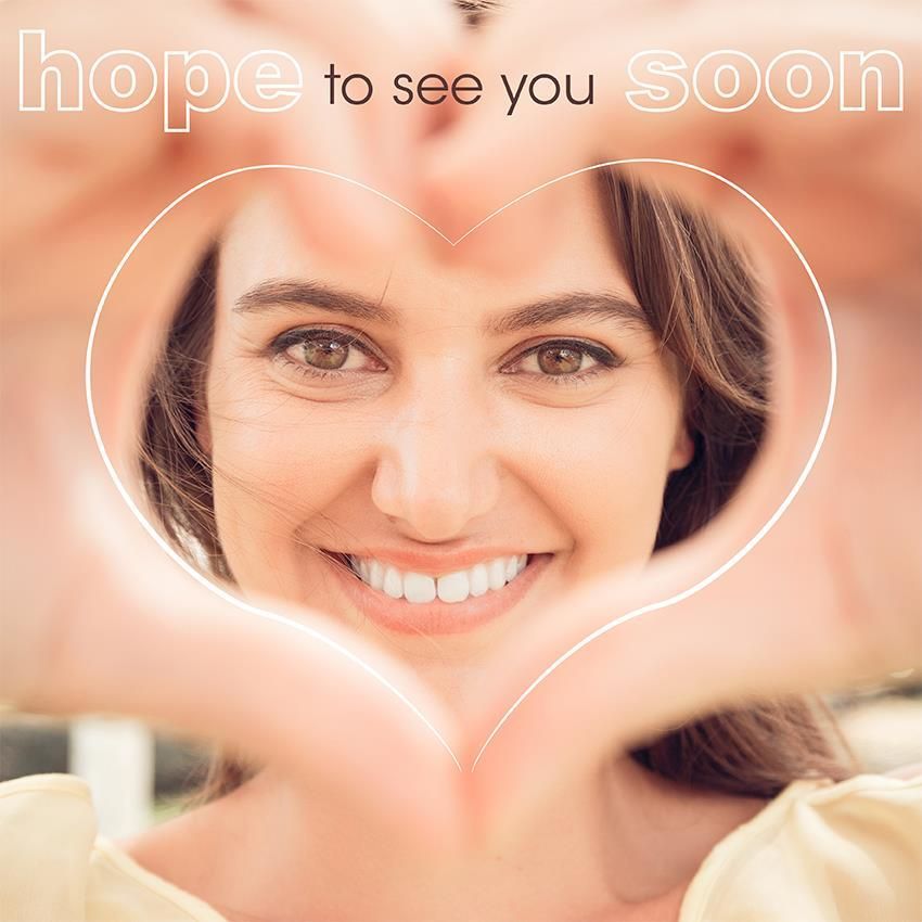 Woman smiling, hands forming a heart frame around her face, text hope to see you soon above. Woman smiling, hands forming a heart frame around her face, text hope to see you soon above.