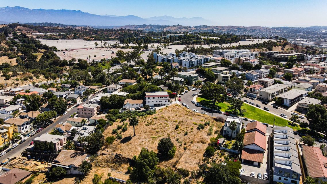 An aerial view of a city with mountains in the background.