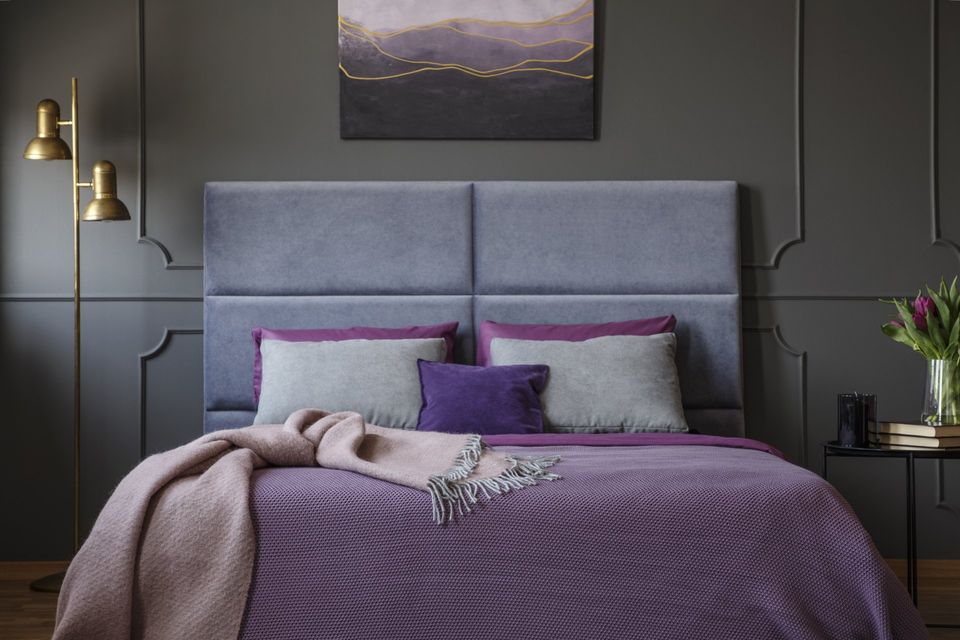 There is a painting on the wall above the bed in the bedroom.
