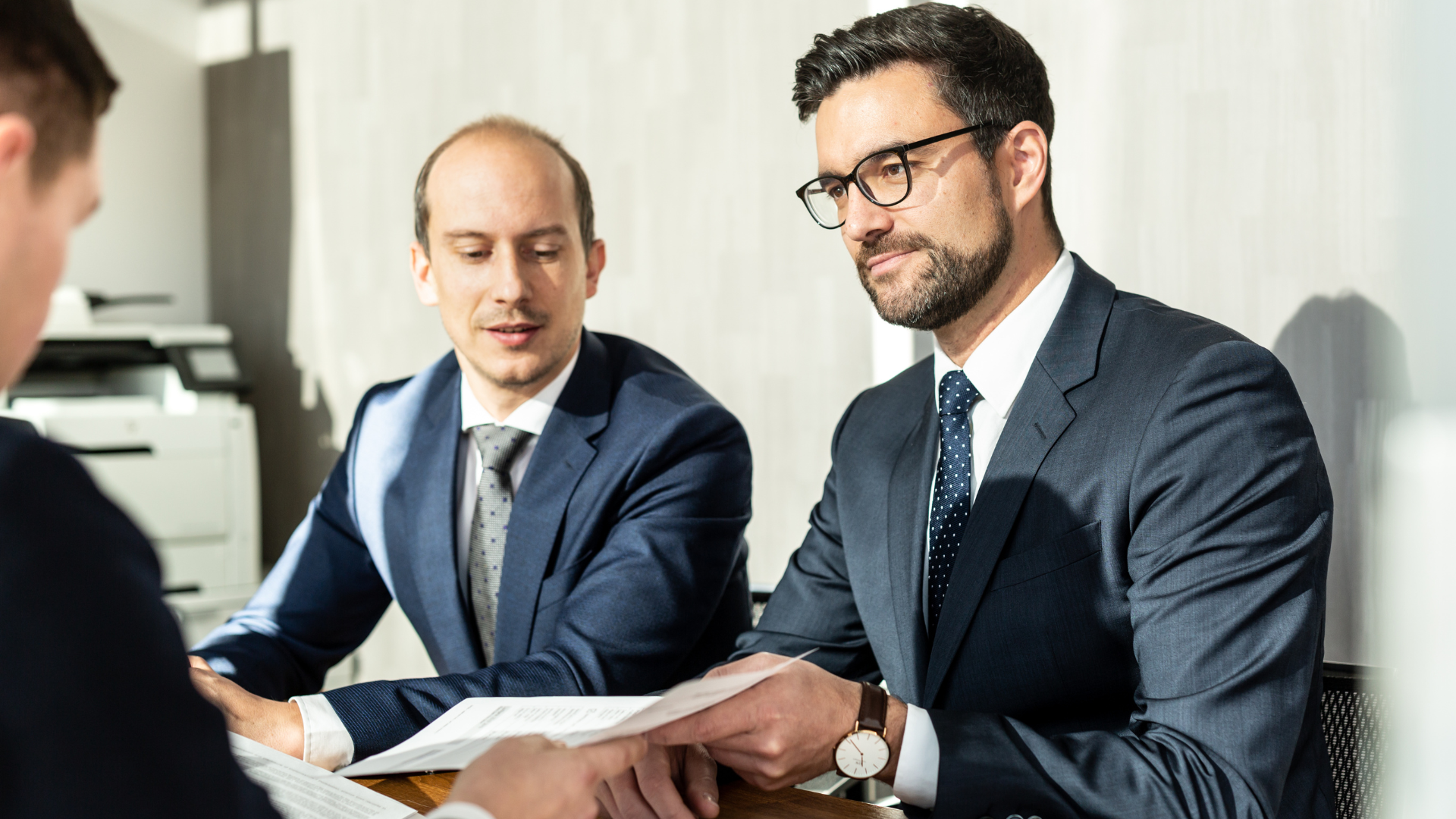 A man is sitting at a desk in a first choice office.