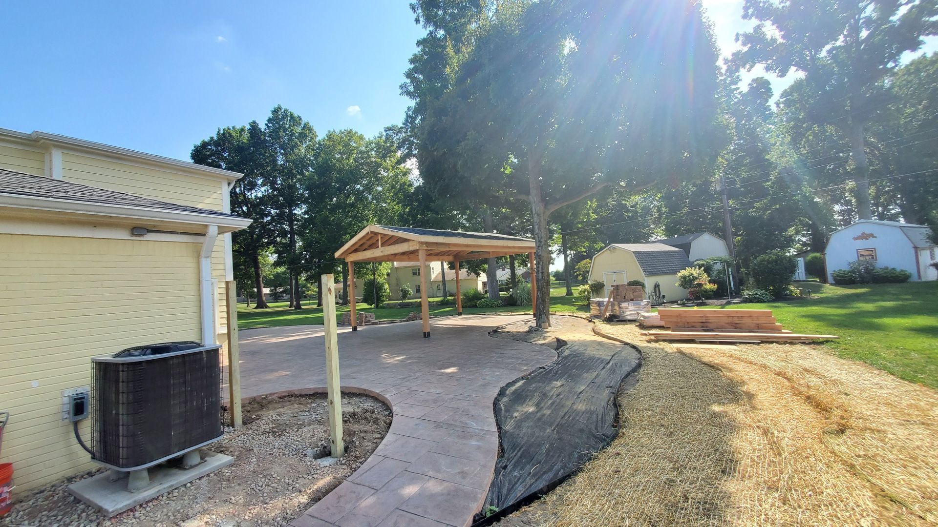 A patio is being built in the backyard of a house.