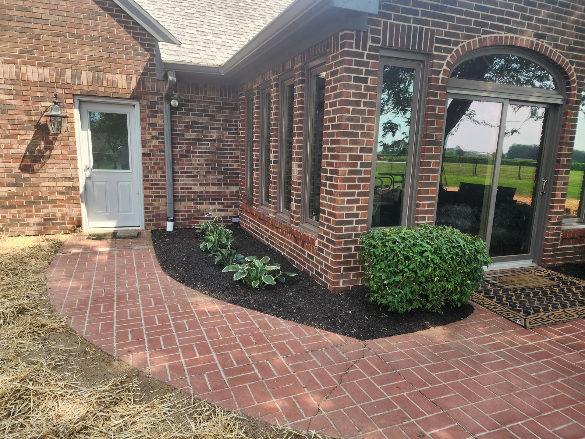 A brick house with a brick walkway leading to it