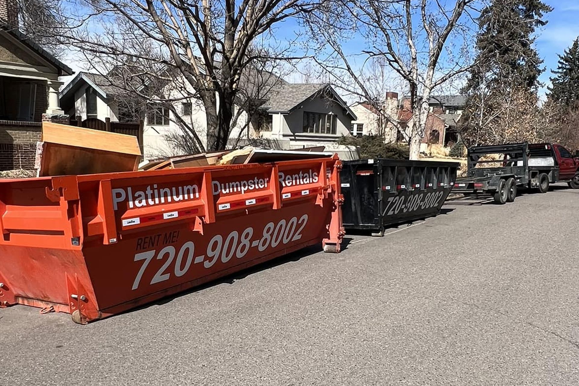 Platinum Dumpster Rentals orange 15-yard dumpster on residential street in Denver