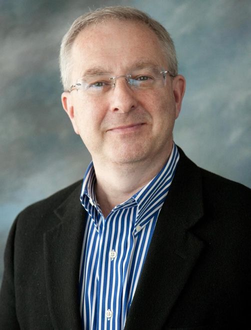 A man wearing glasses and a blue and white striped shirt