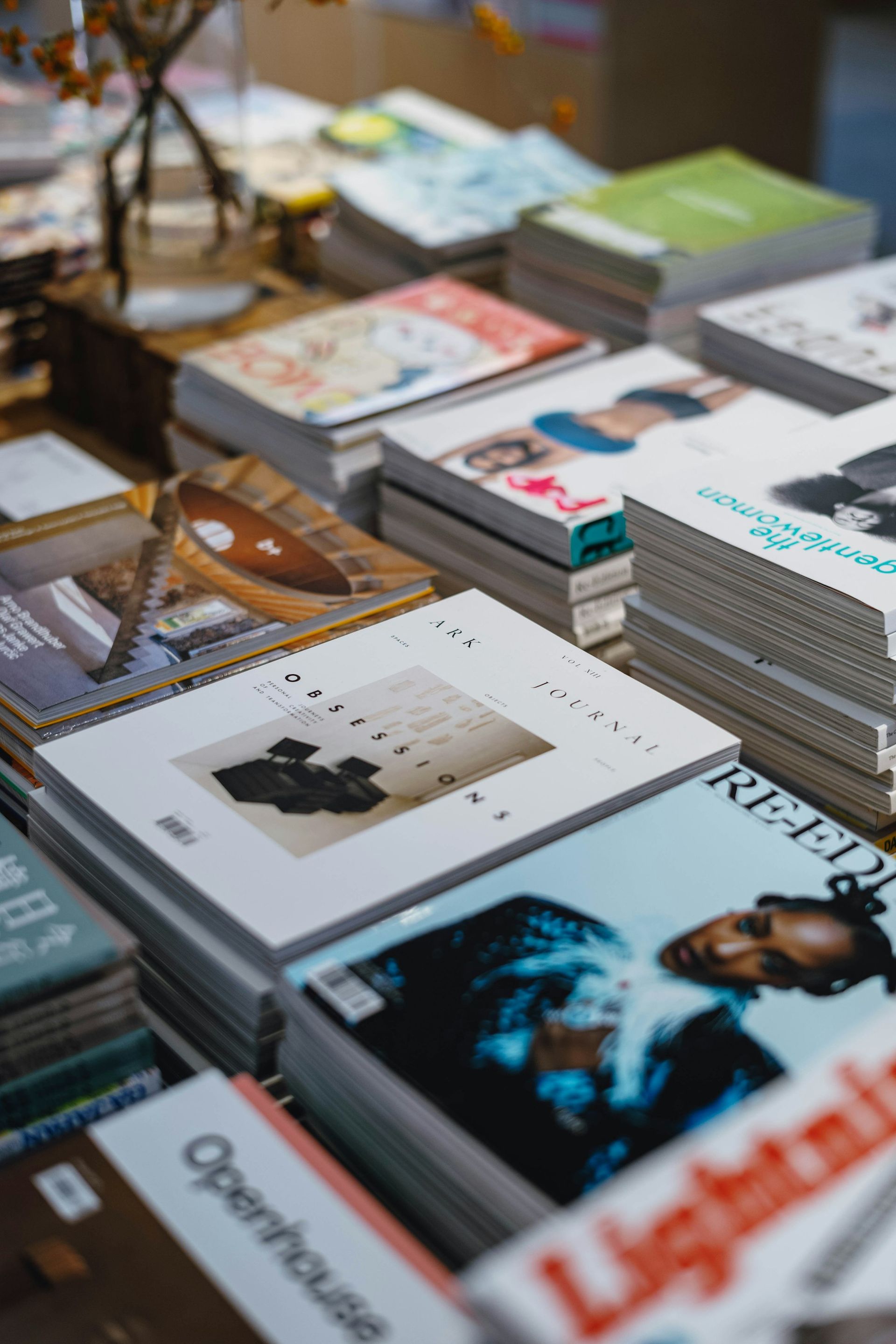 Stacks of design and lifestyle magazines on a wooden table