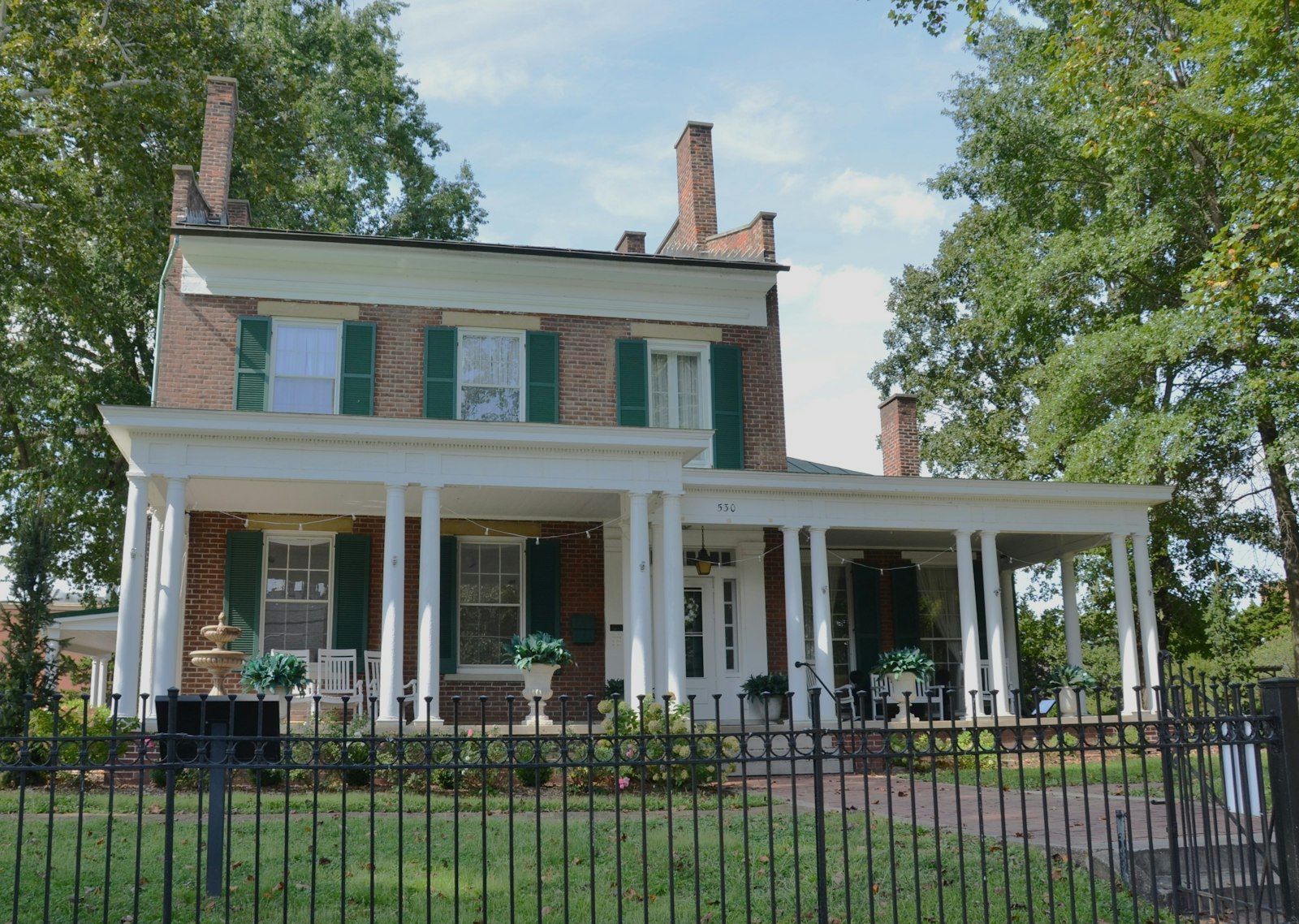 A brick house with a white columned porch