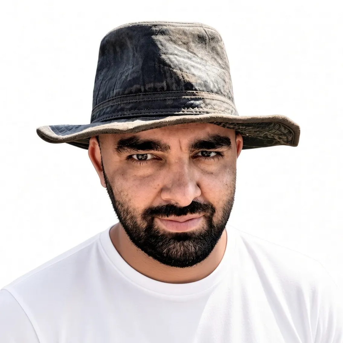 Man in a worn black hat and white shirt, facing forward with a neutral expression against a plain white background