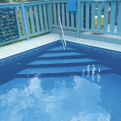 Blue-painted swimming pool with ladder and wooden deck railing, viewed from above