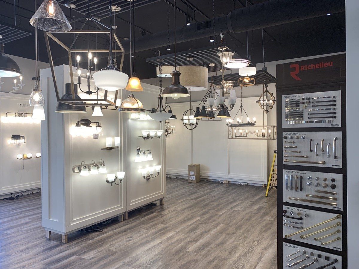 Lighting showroom with hanging pendant lights and wall-mounted fixtures on display