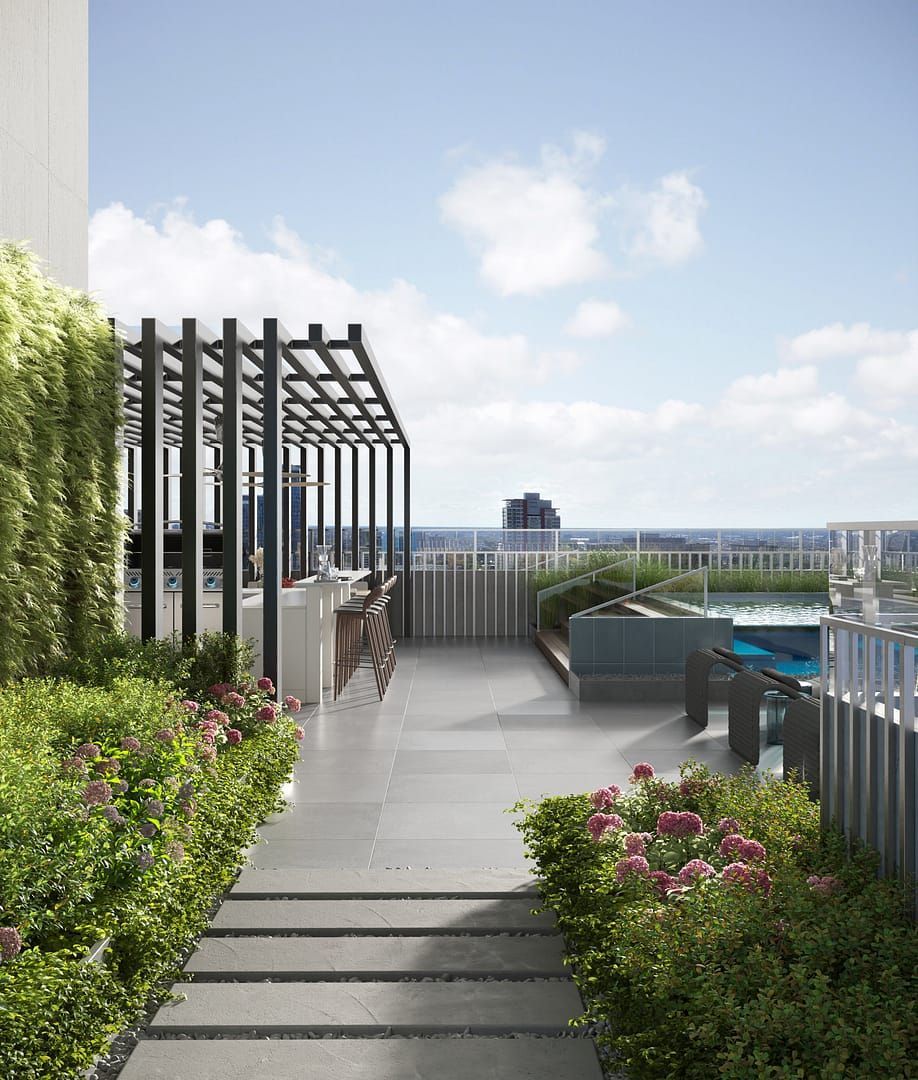 Rooftop garden walkway with greenery, pink flowers, pergola, and city skyline beyond the railing