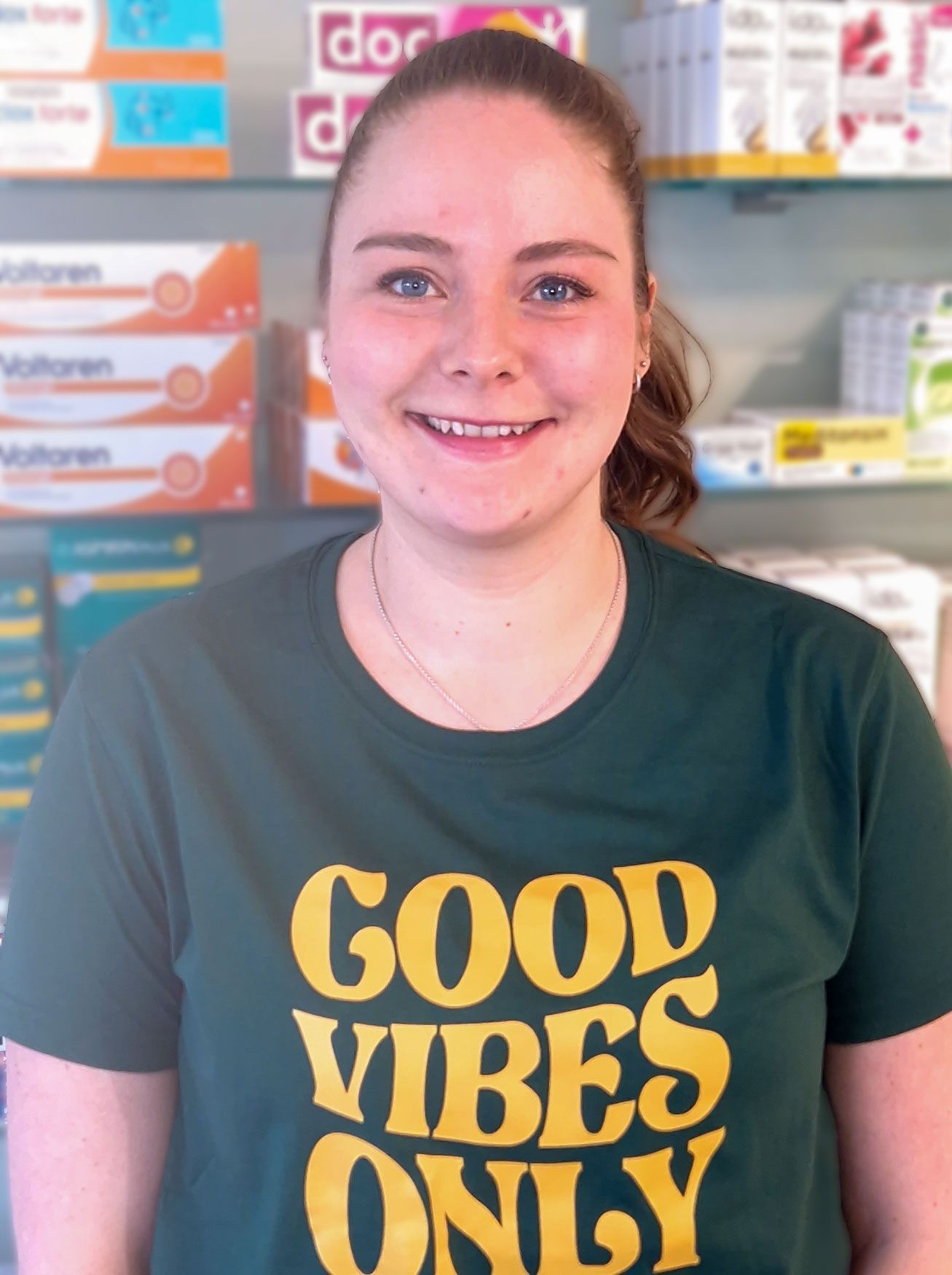 Eine Frau, die ein grünes T-Shirt mit der Aufschrift „Good Vibes Only“ trägt
