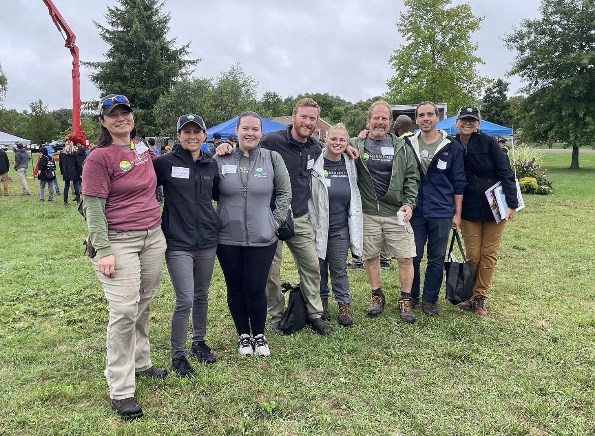 A group of people are posing for a picture in a field.