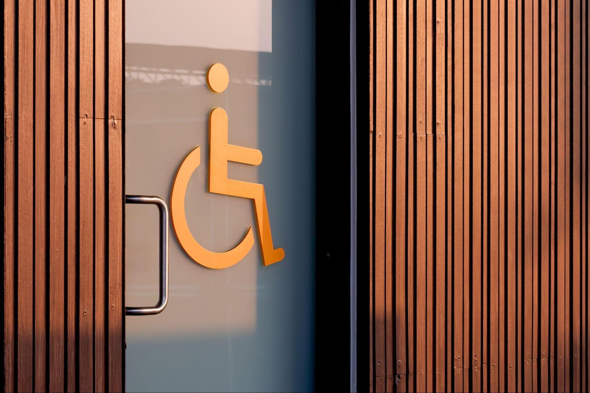 Accessible entrance with wheelchair symbol highlighting TAS/ADA inspection Huntsville accessibility requirements.