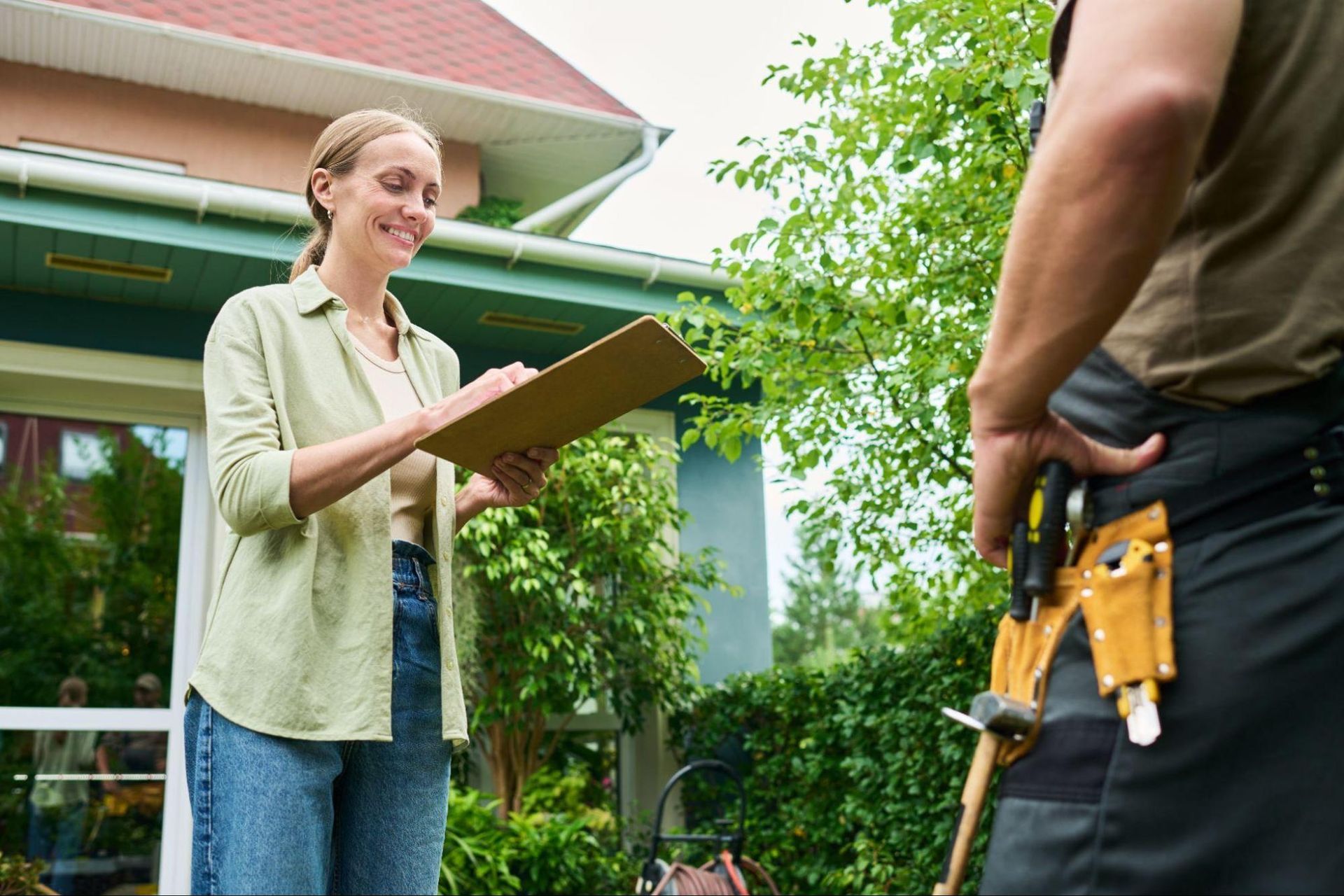 Home Inspection Fall Creek professional reviewing documents with a homeowner