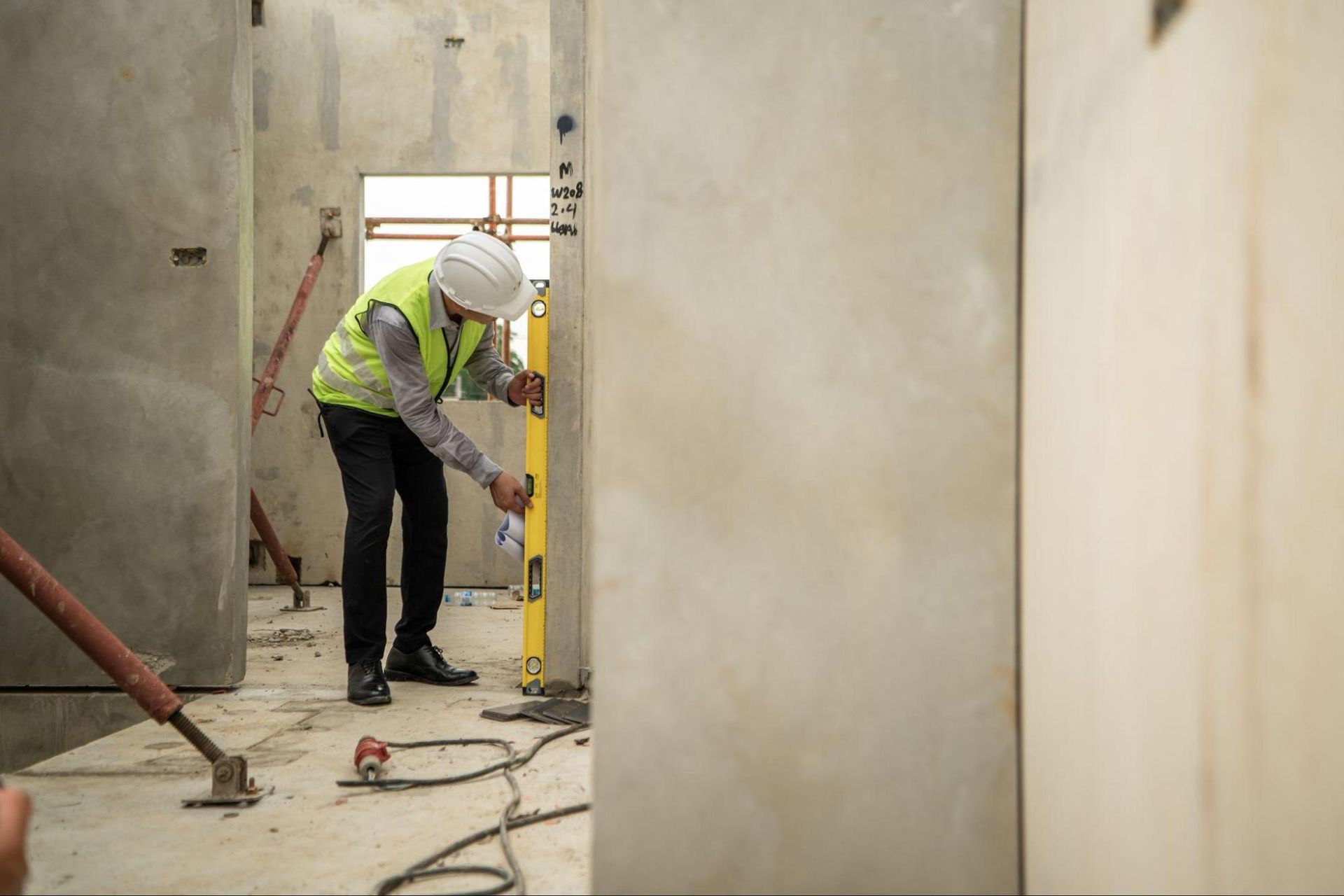 Inspector checking doorway alignment during a commercial accessibility inspection