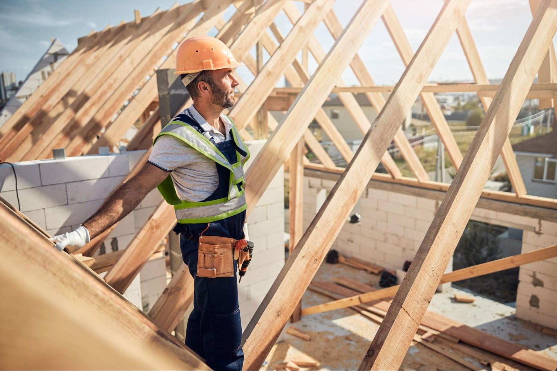 Worker reviewing roof framing for coordination.