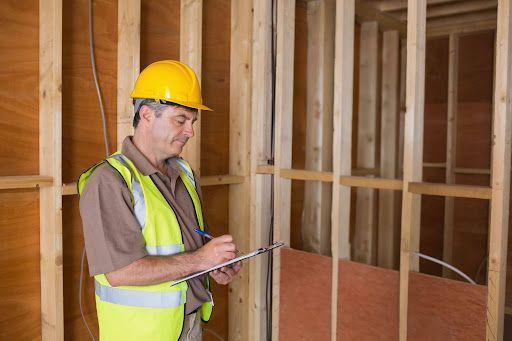 Professional inspector reviewing framing and structure during a home inspection