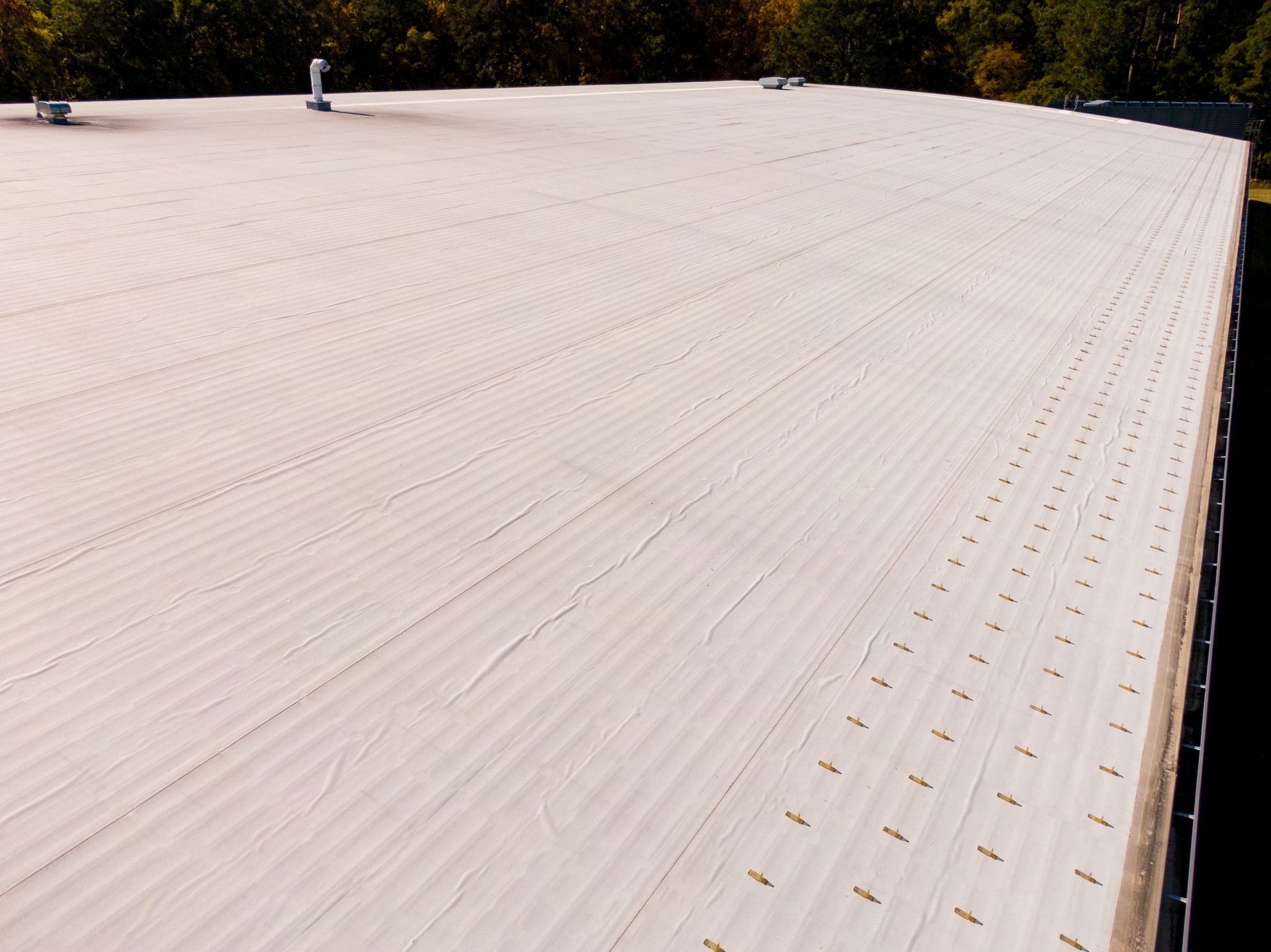 Sunny daytime drone images of a large commercial roof. Sunny daytime drone images of a large commercial roof.
