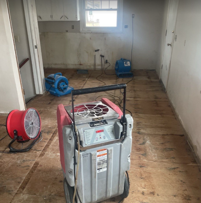 A machine is sitting on a wooden floor in a room.