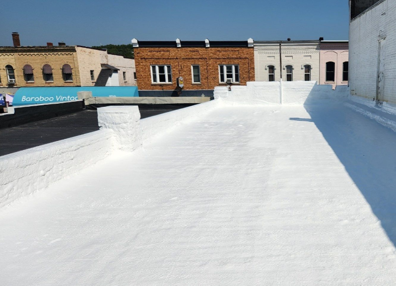 A white roof with a few buildings in the background
