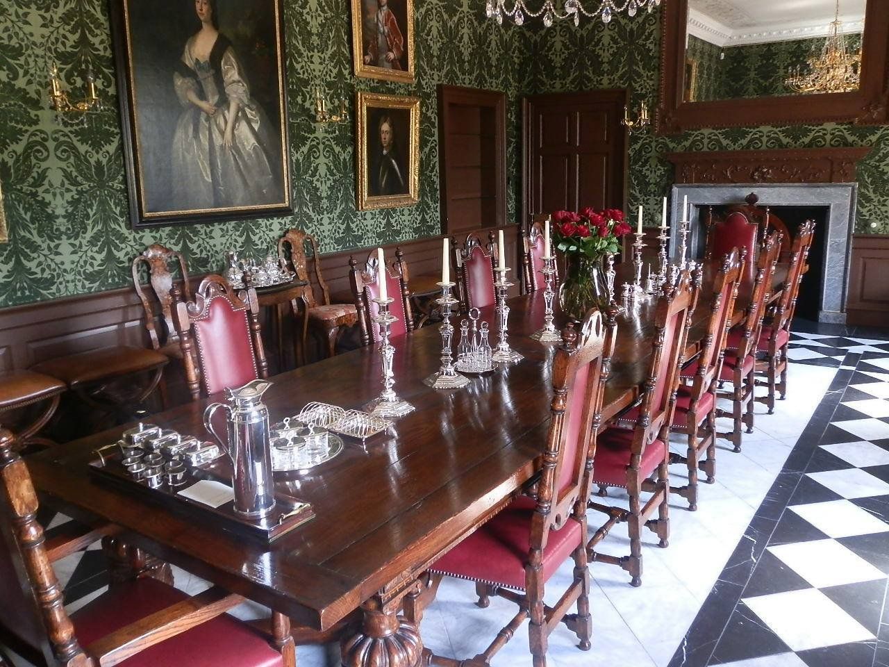 Large table and chairs with silver ware on top