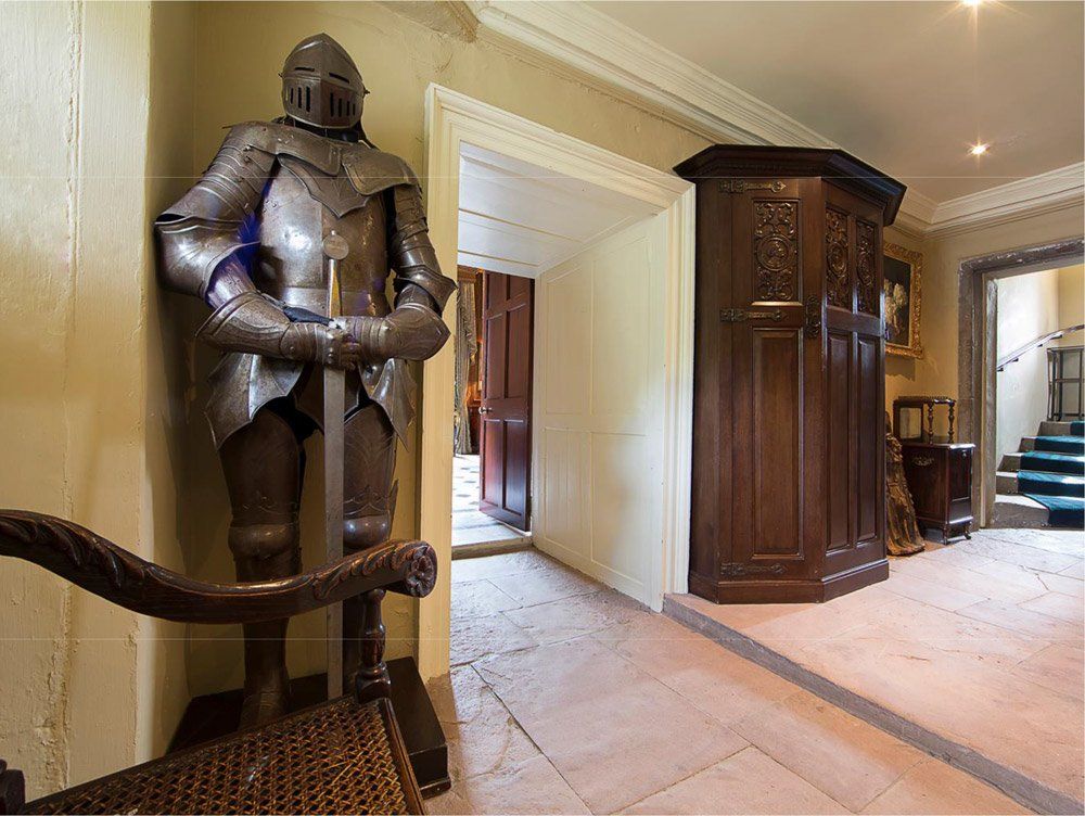 Suit of armour next to door way in Killochan Castle, Girvan