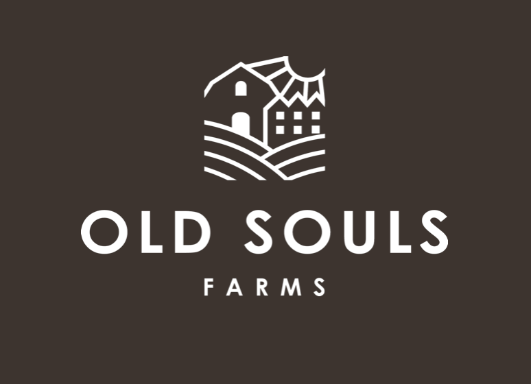 Logo for Old Souls Farms featuring a white farm building illustration above text.