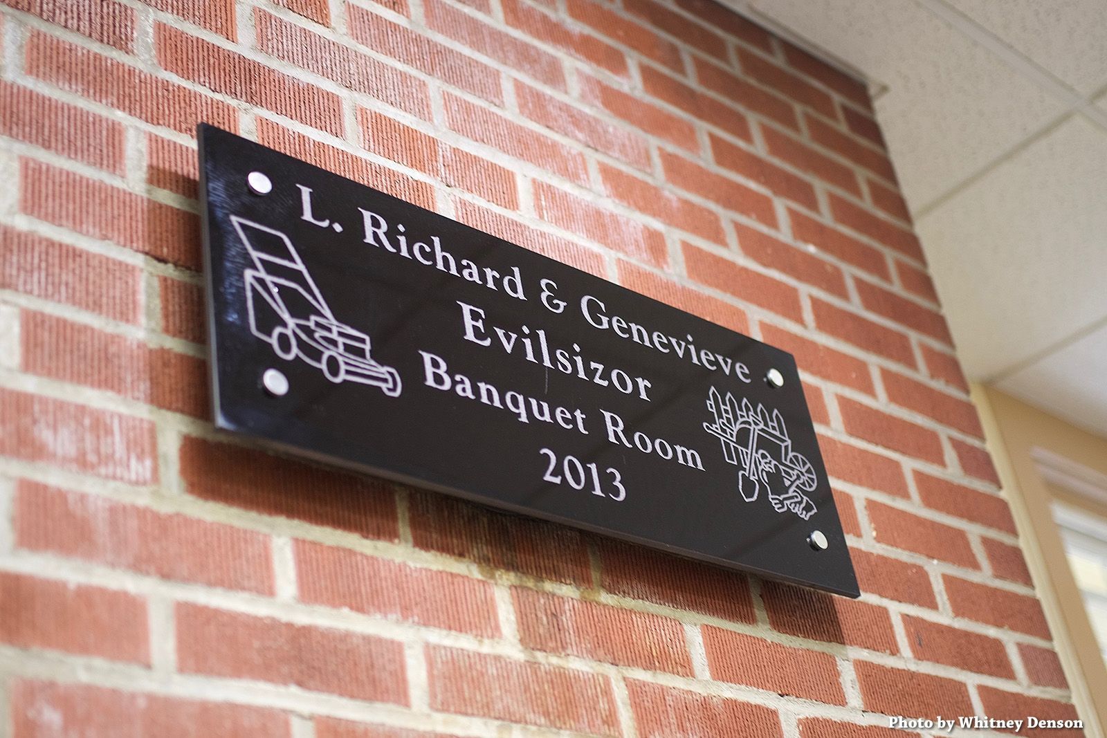 Black plaque on brick wall: 