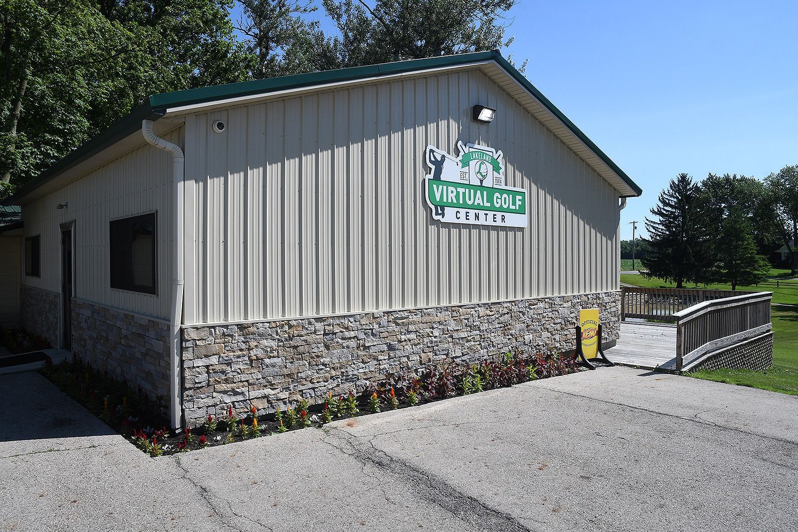 Building with metal siding and stone base, sign 