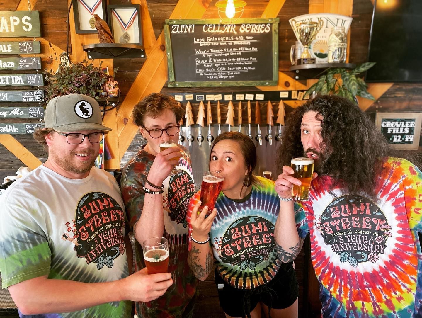 A group of people are drinking beer in a bar.
