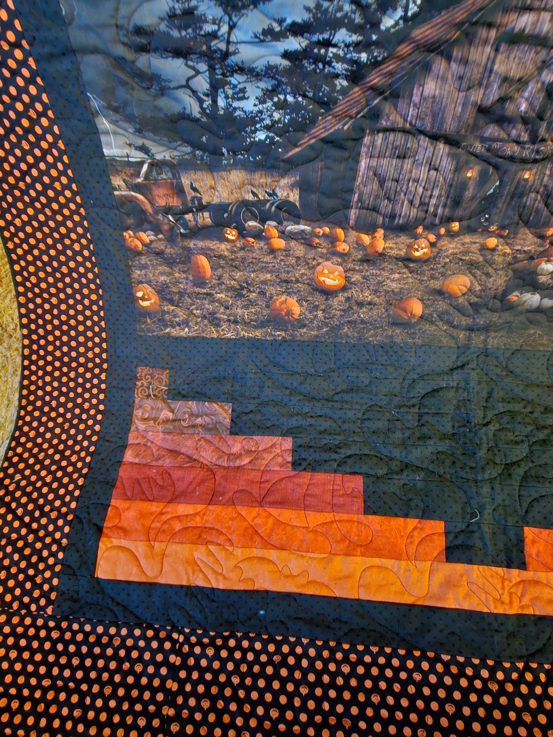Quilted autumn scene with pumpkins, trees, and orange-red patchwork border