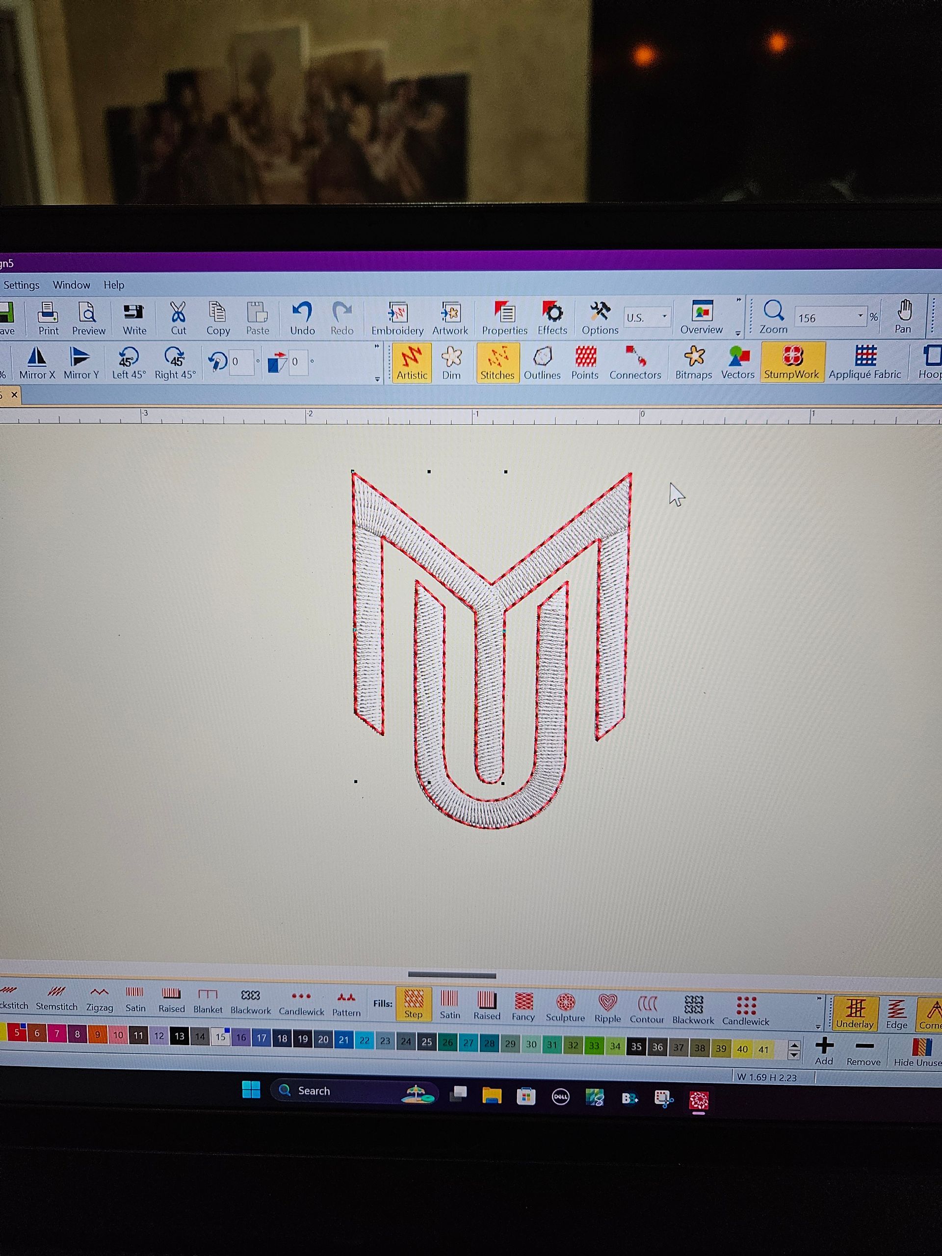Computer screen showing a design program with a red-and-gray geometric logo sketch on a white canvas.