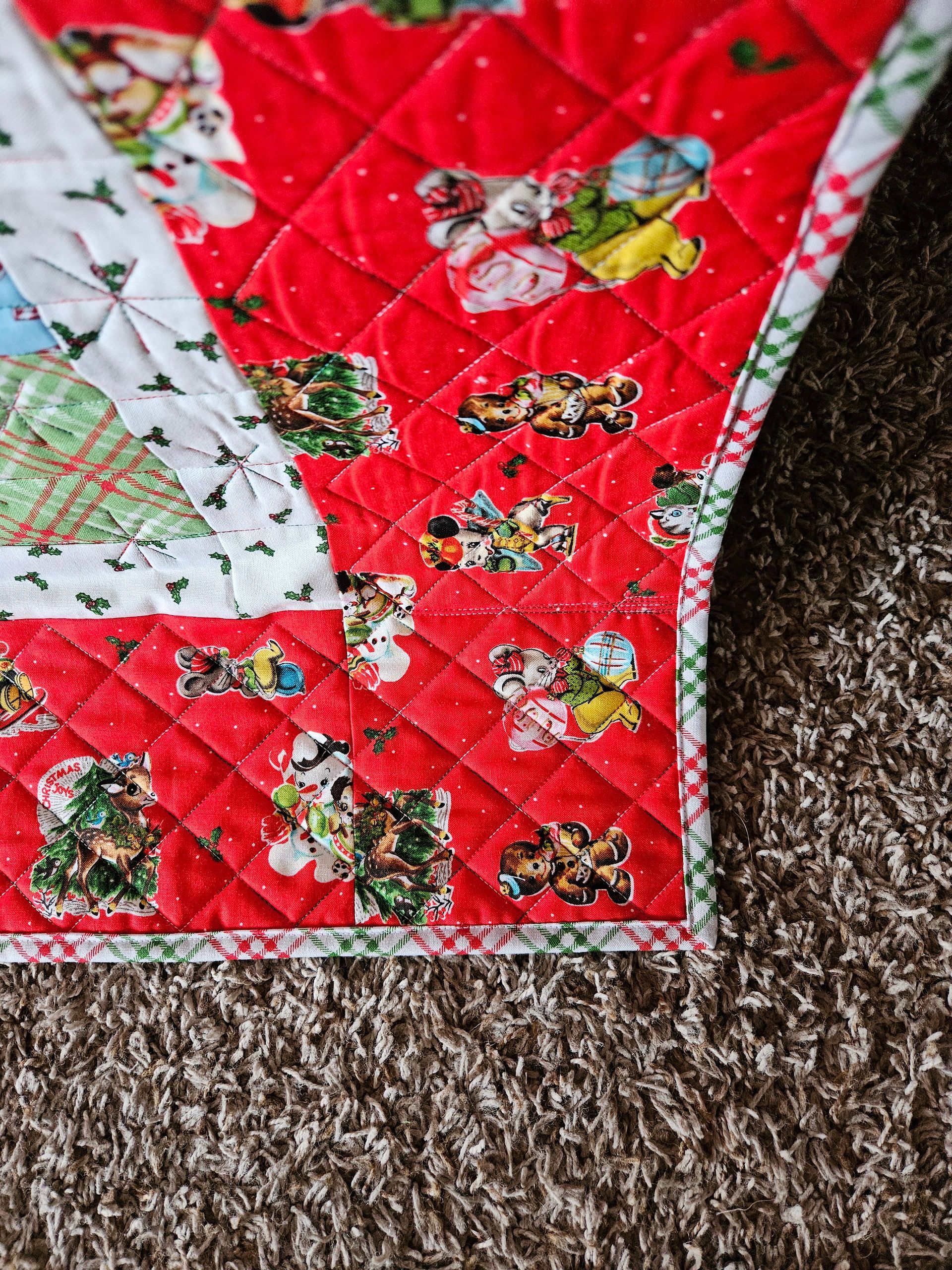 Red-and-white floral quilt corner on brown carpet