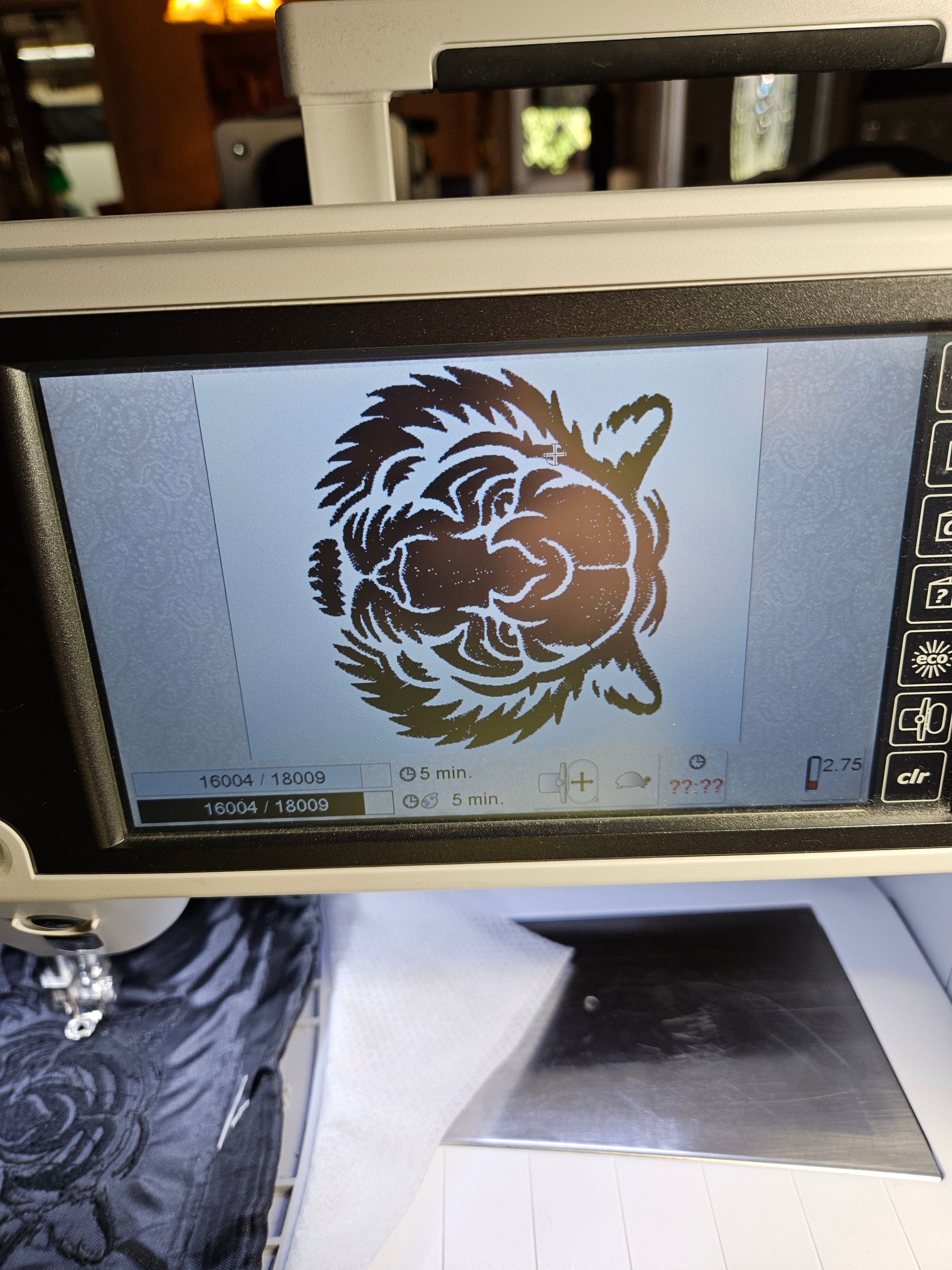 Laptop screen displaying a black tribal-style lion graphic on a white background