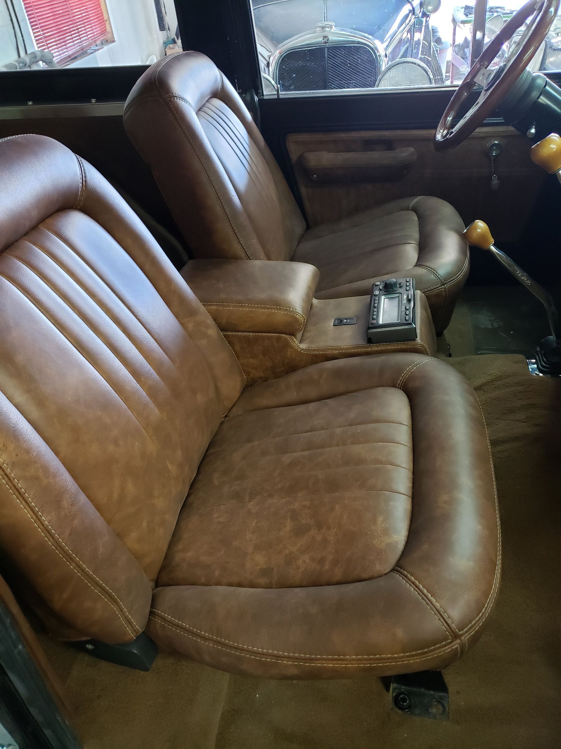 Brown leather car seats and center console inside a vehicle interior