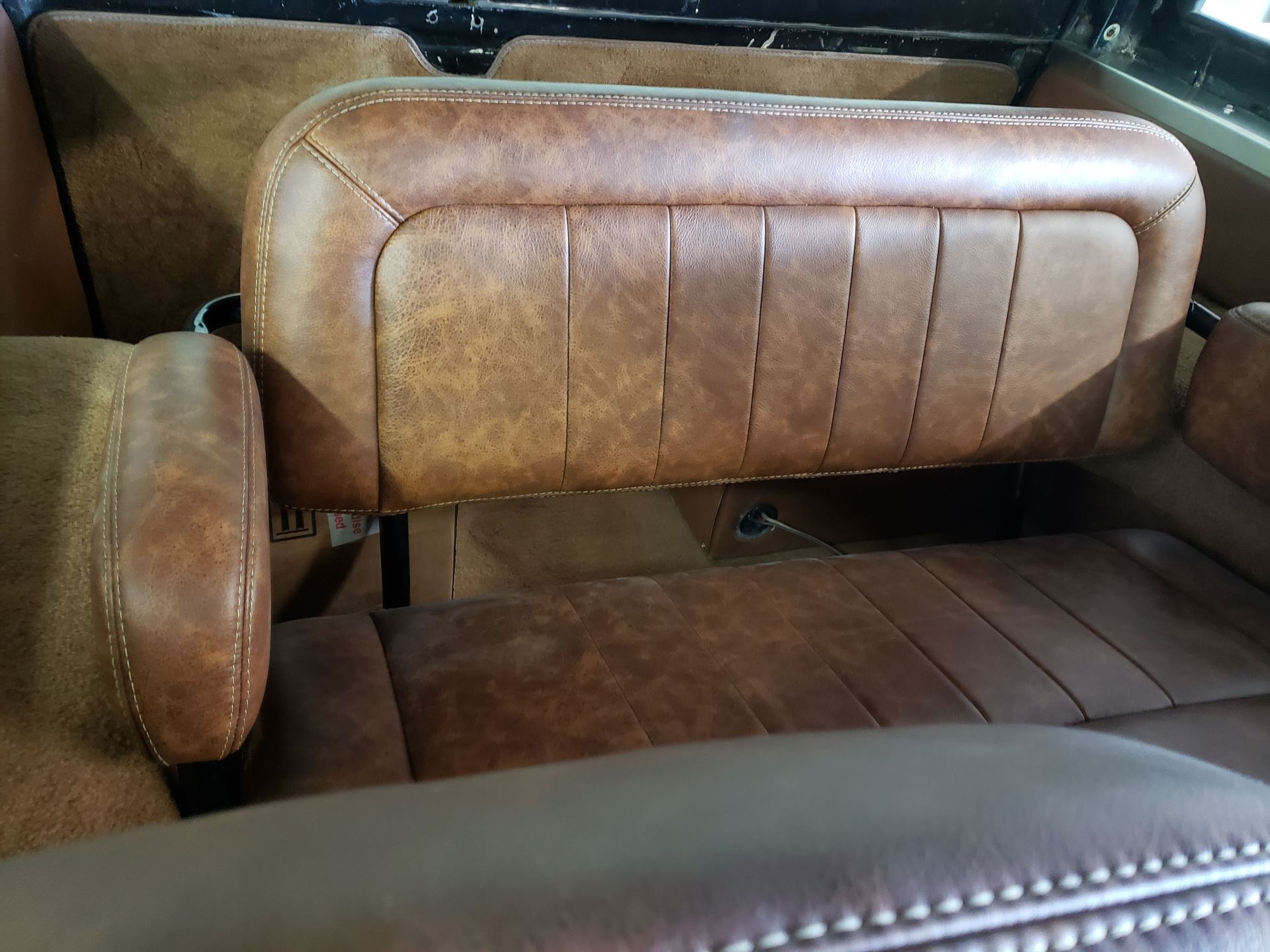 Brown leather car seats in a vintage vehicle interior