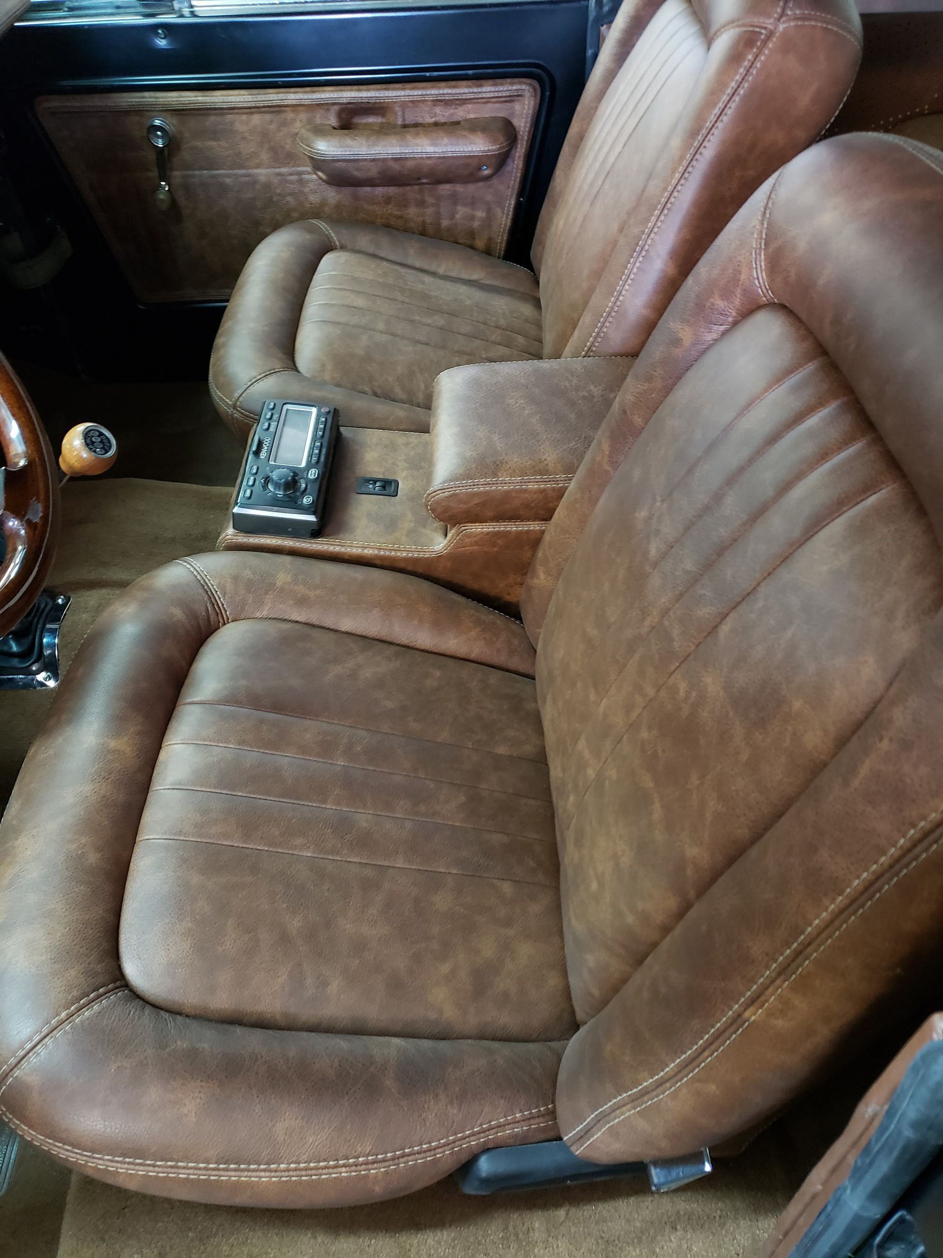 Tan leather car seats with center console and door panel visible inside the vehicle