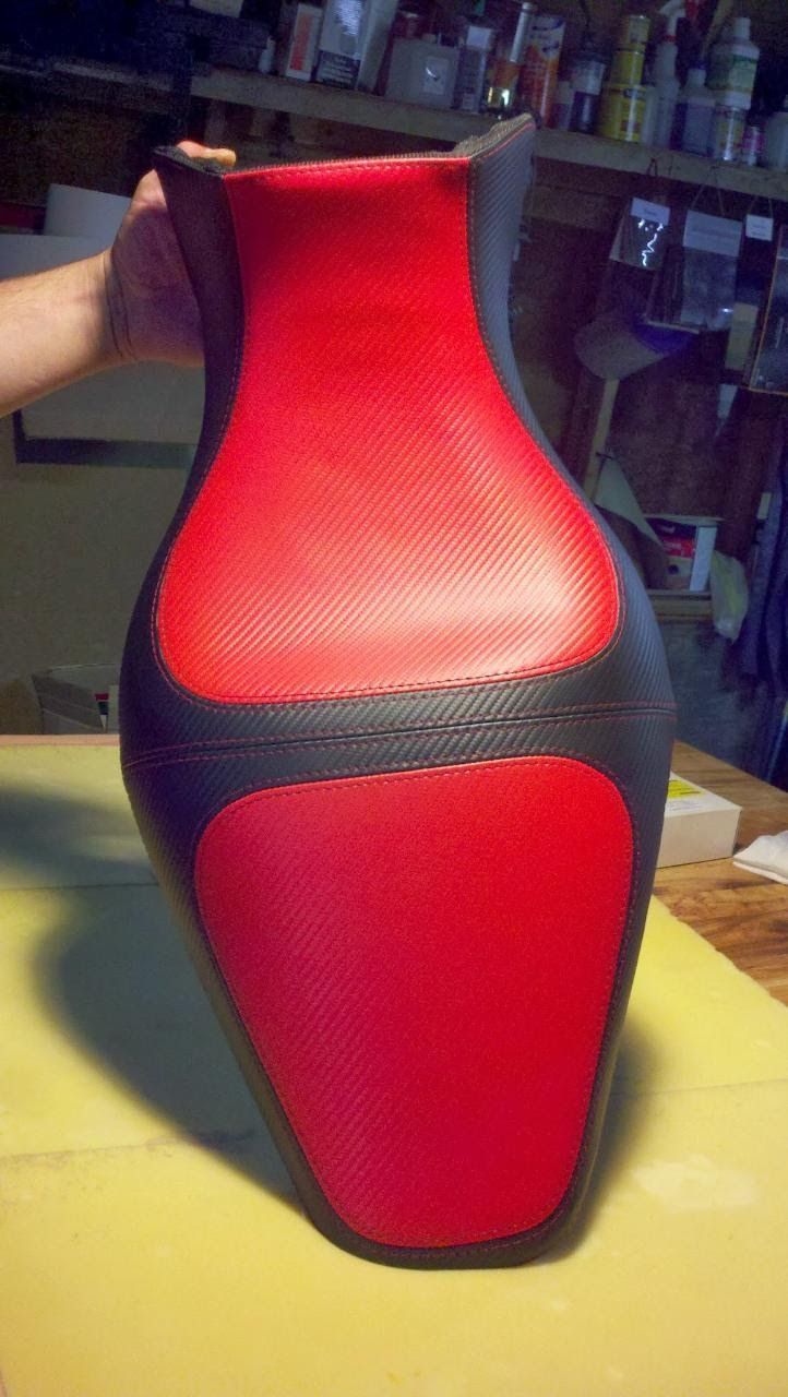 Red and black speaker standing on a table in a workshop-like room