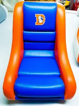 Blue and orange padded chair with a white “D” logo on the backrest