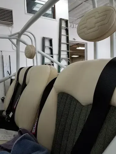 Close-up of beige car seats with black accents inside a vehicle showroom