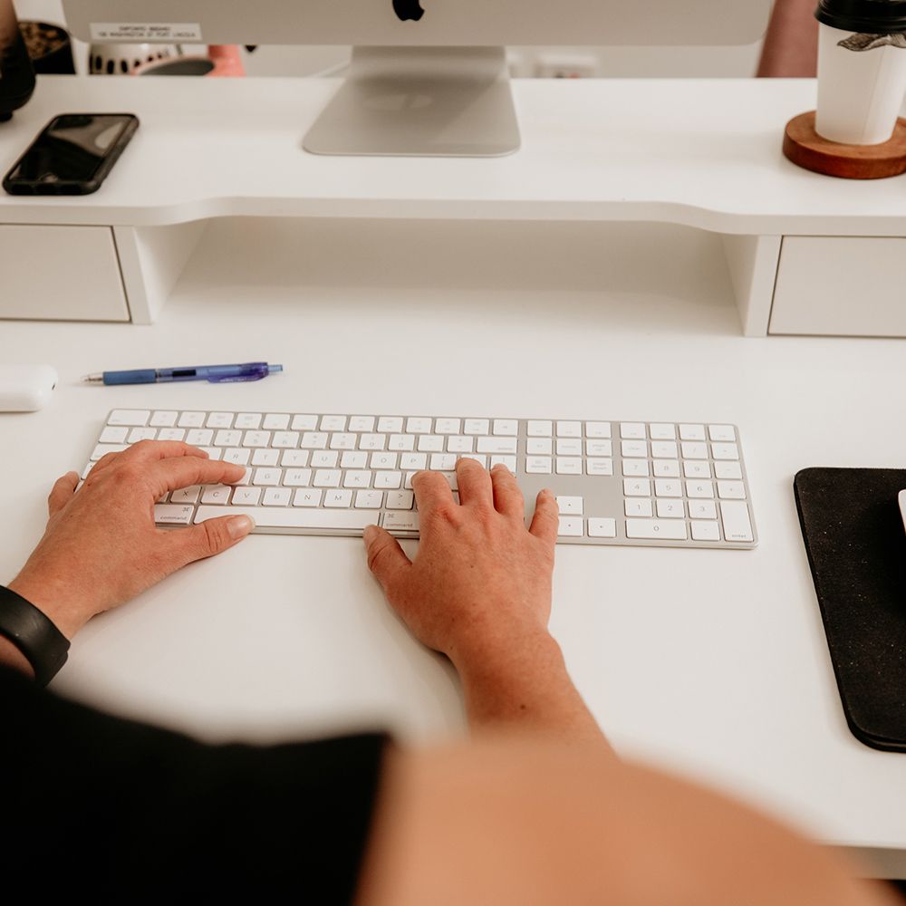 a woman typing on a keyboard