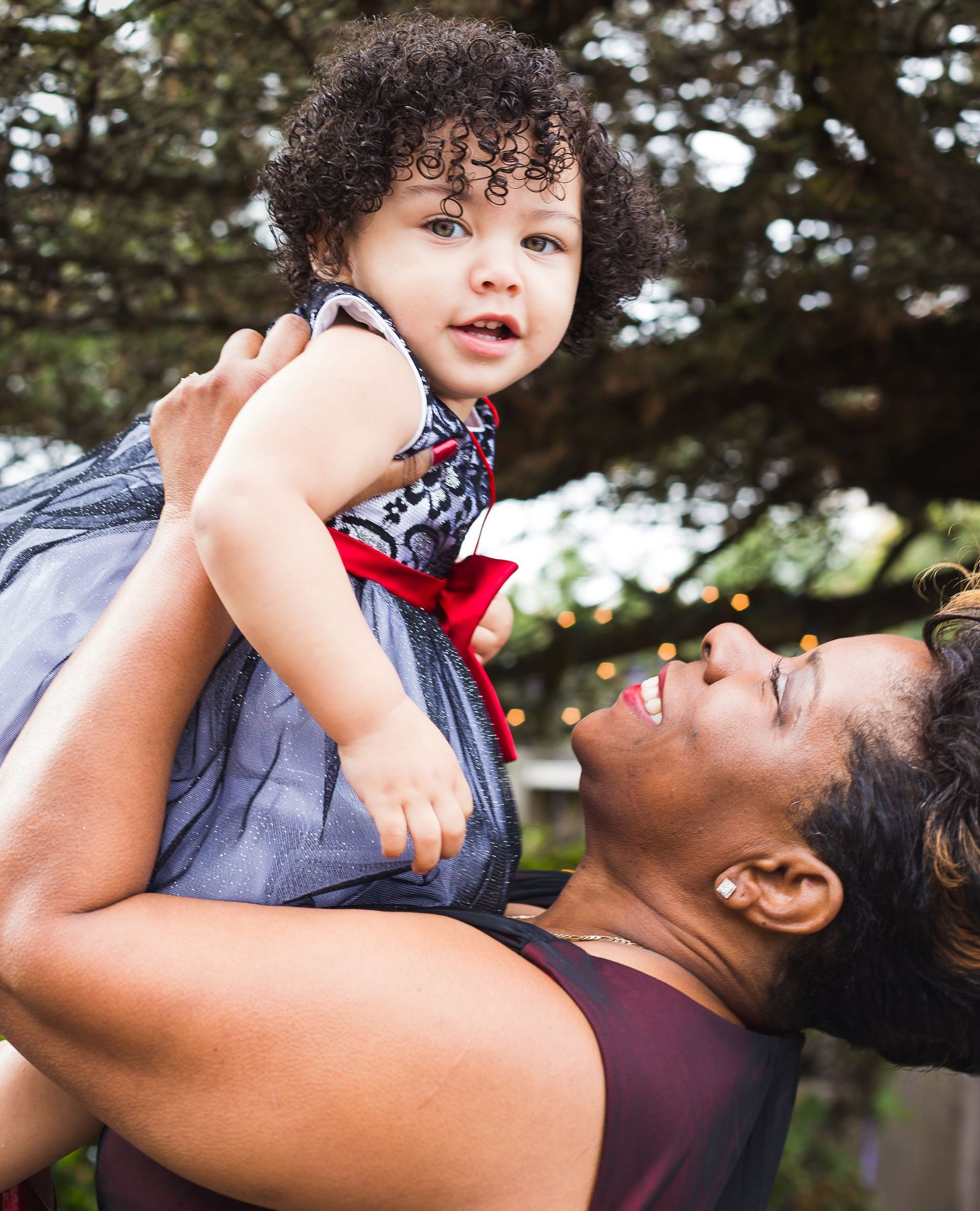 A woman is holding a little girl in her arms.