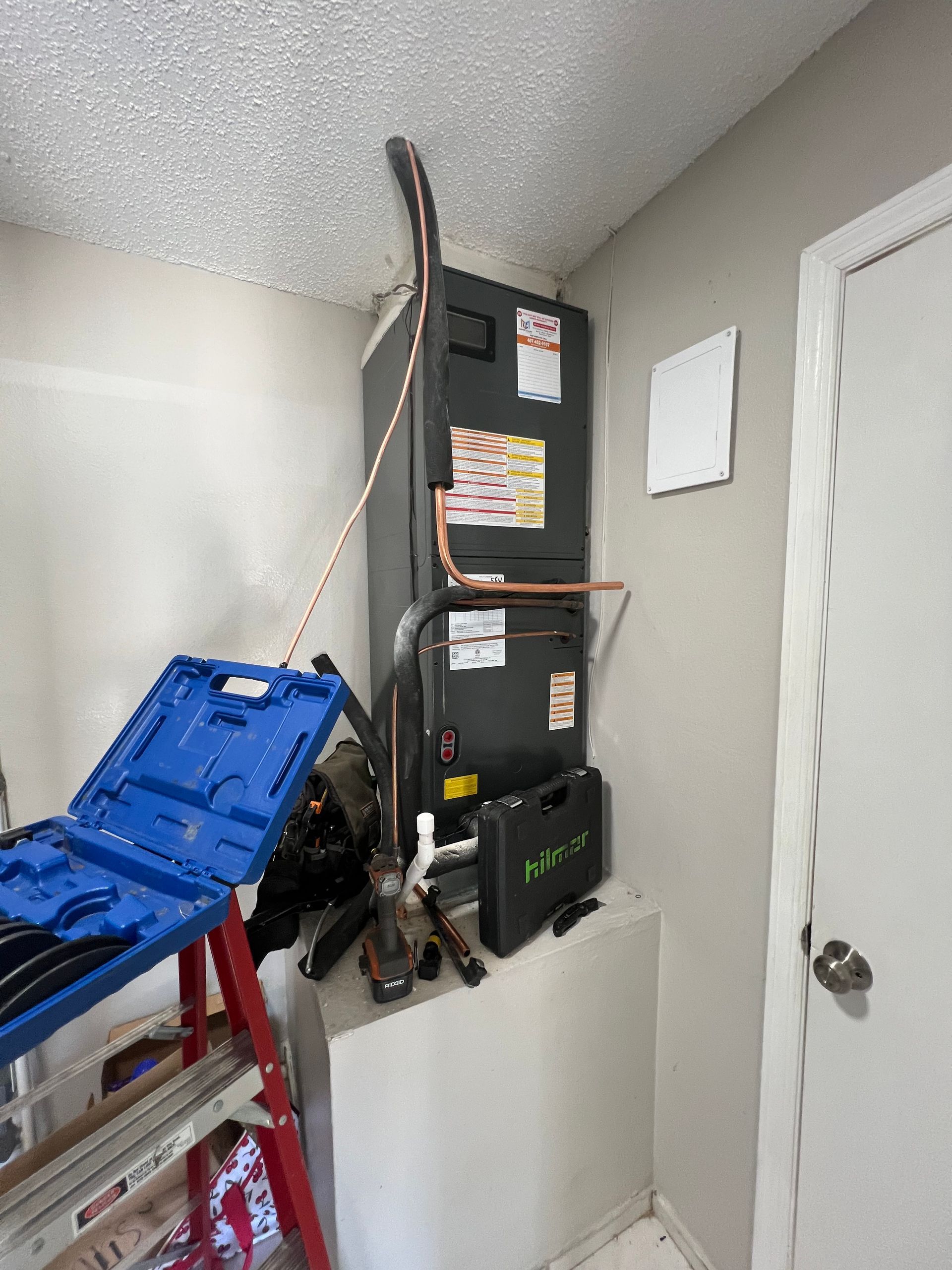 a room with a ladder and a heater in it .