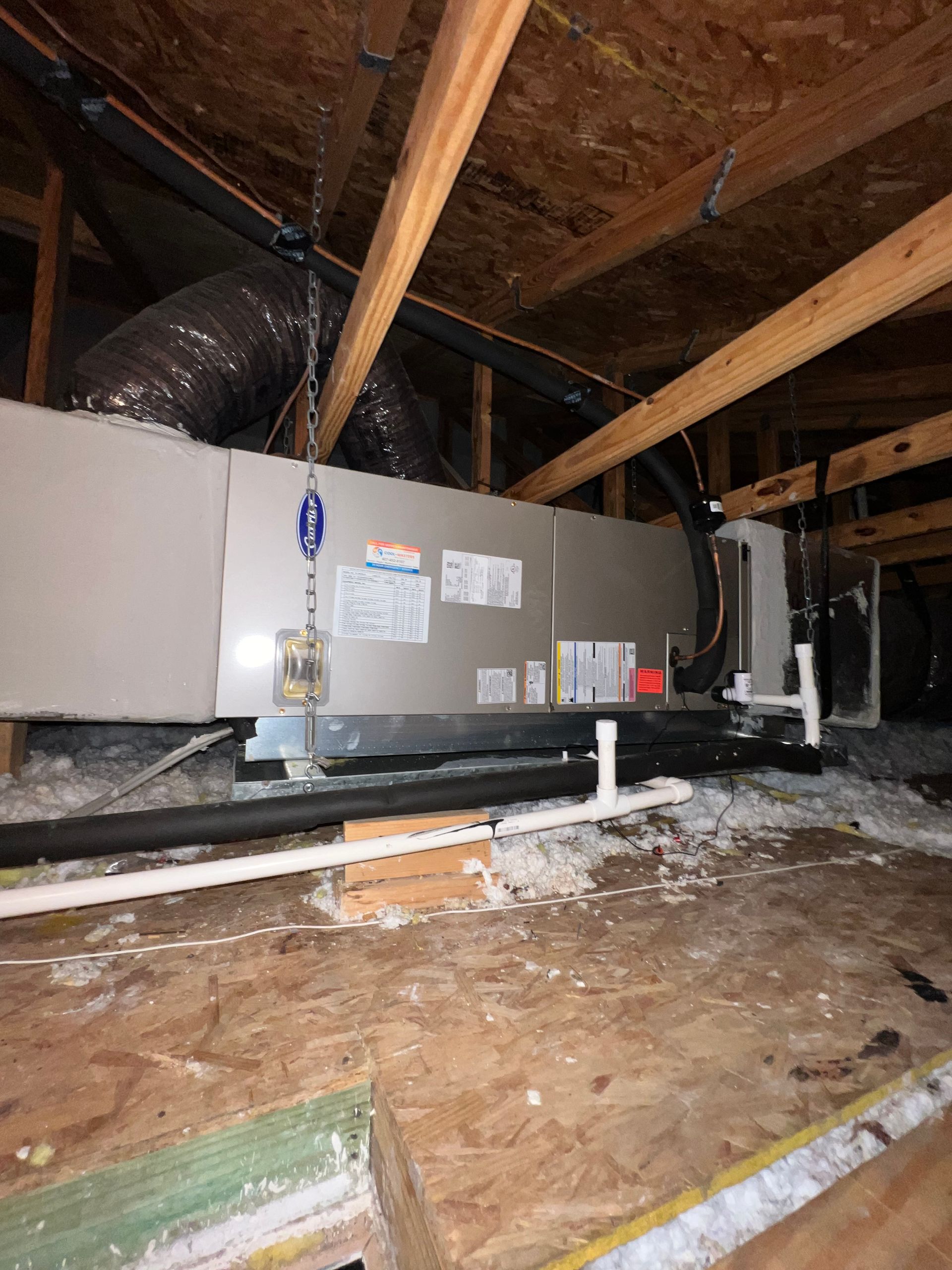 an air conditioner is installed in the attic of a house .