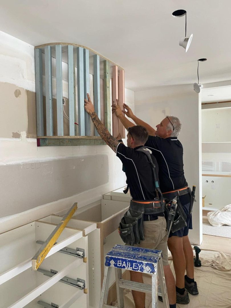 Two Tradesmen Install An Overhead Cabinet — Reynolds Built In Moffat Beach, QLD