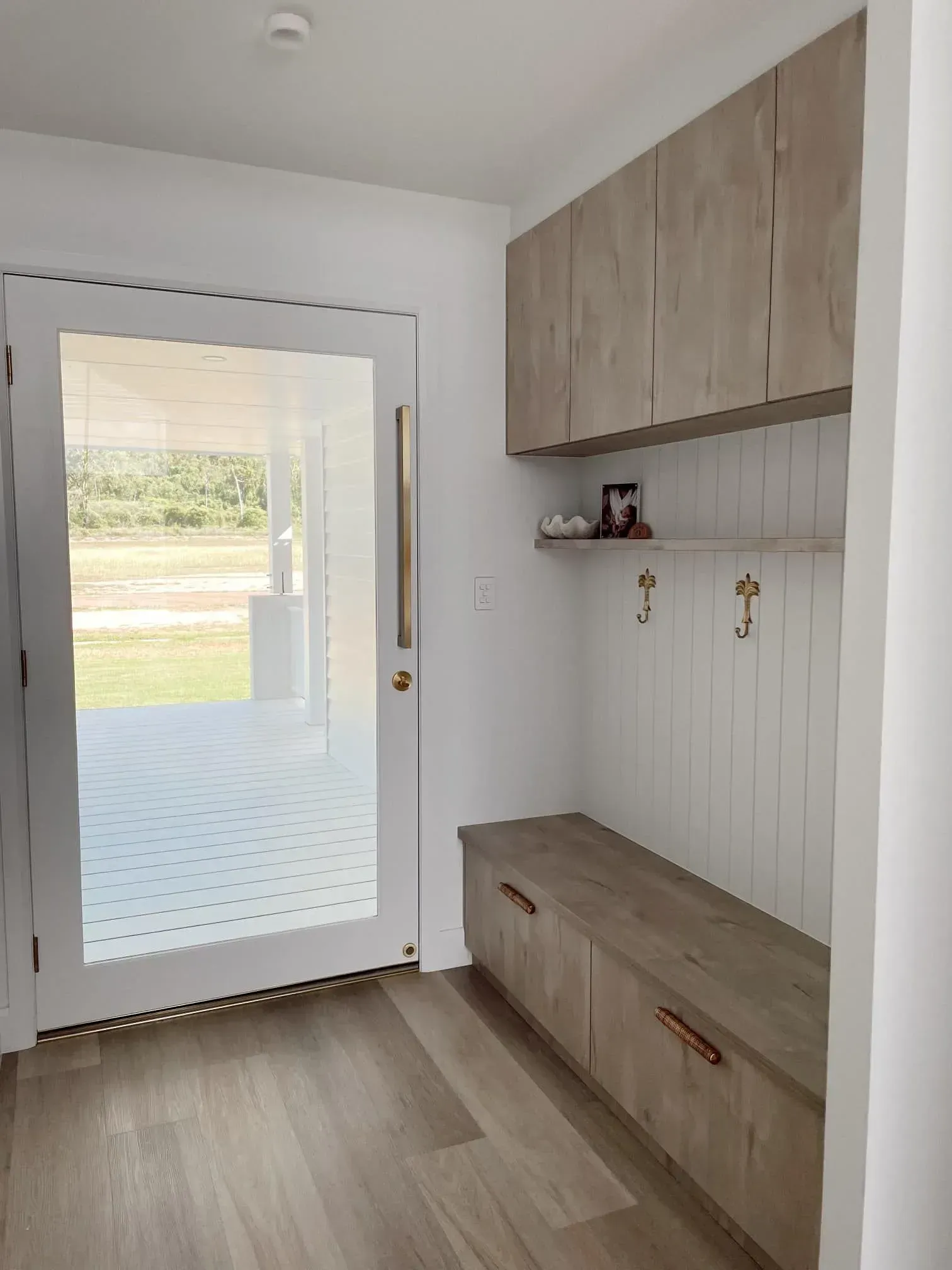 A Hallway With A Sliding Glass Door And A Bench — Reynolds Built In Moffat Beach, QLD