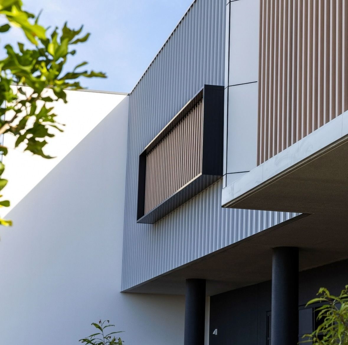 A Low-angle View of a Modern Building With Corrugated Metal Siding — Reynolds Built In Golden Beach, QLD