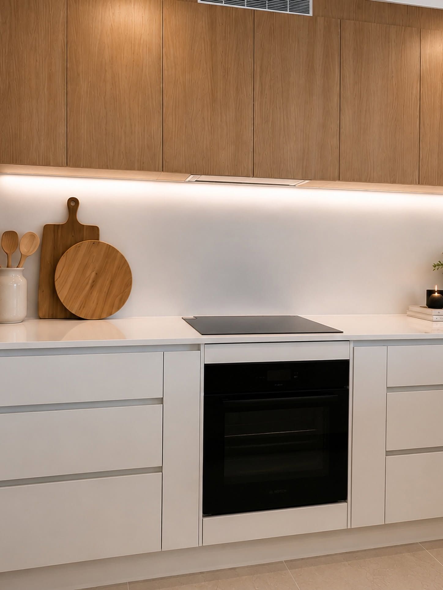 Modern White Kitchen With Wood Cabinets, Built-in Oven, Cooktop, and Under-cabinet — Reynolds Built In Moffat Beach, QLD