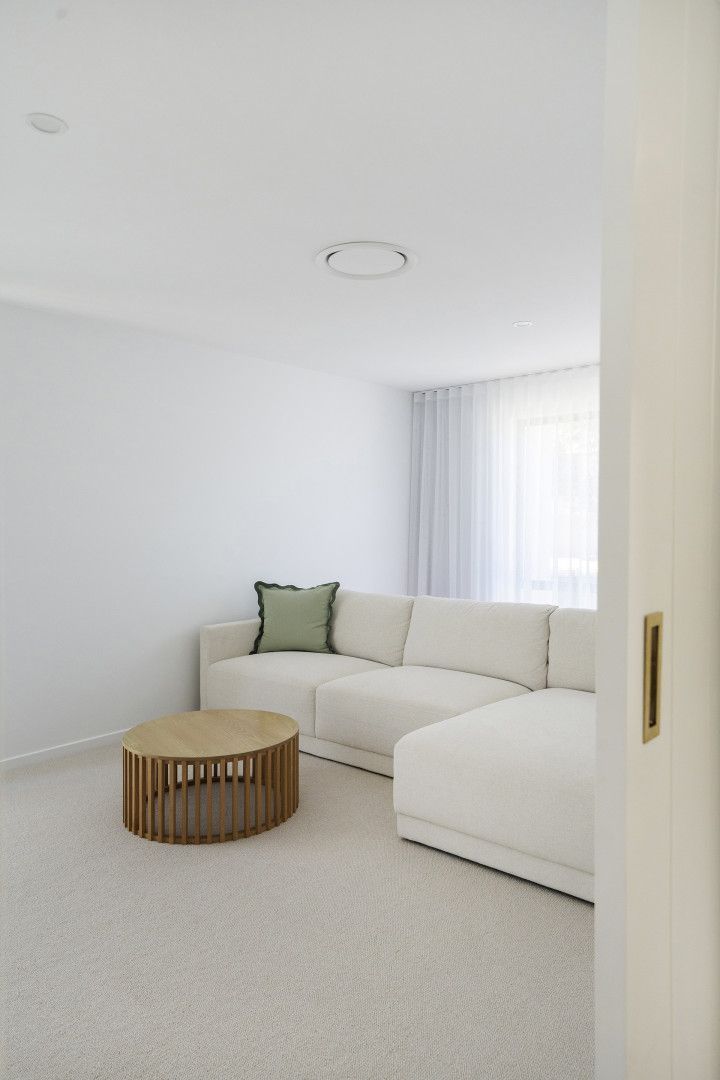 Minimalist Living Room With a White Sectional Sofa — Reynolds Built In Moffat Beach, QLD